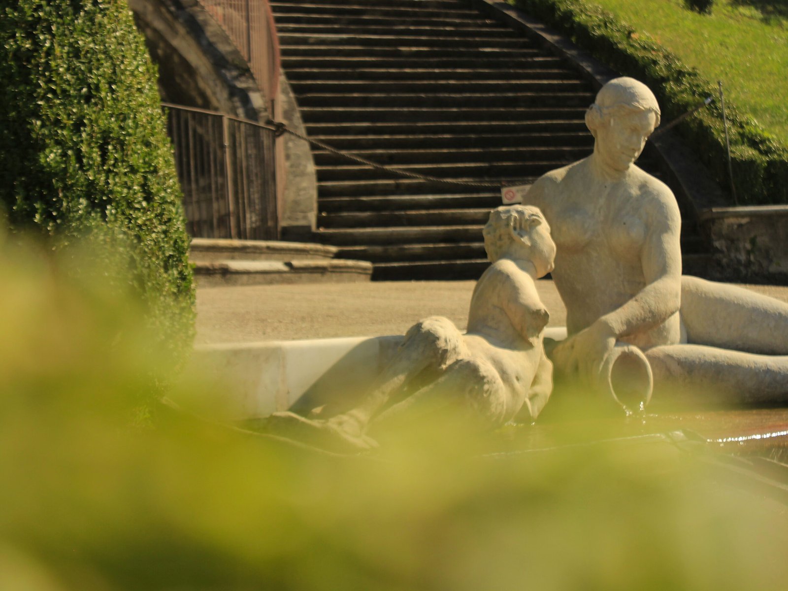 Statues of mother and son pouring running water in Villa della Regina, Torino, 2025
